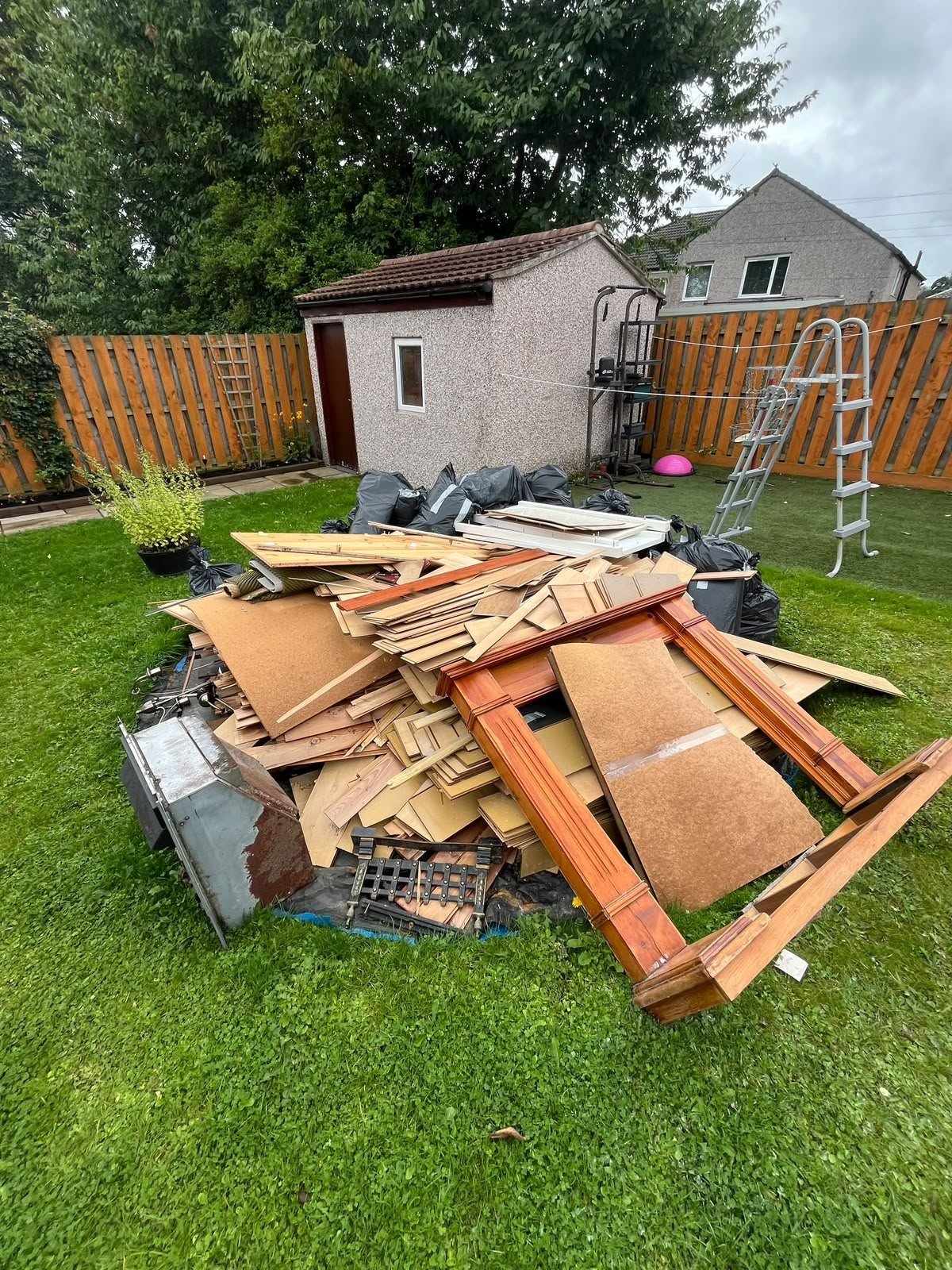 Back garden in Glasgow being cleared of old timber and furniture
