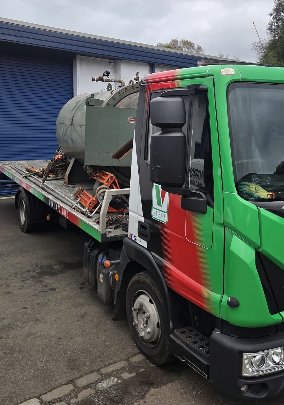 Verde recovery truck carrying a scrap metal tank